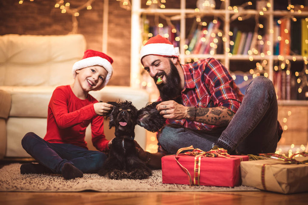 Christmas happy boy and father with puppy. - Photo, Image