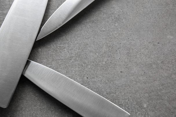 Knifes on grey background - 写真・画像