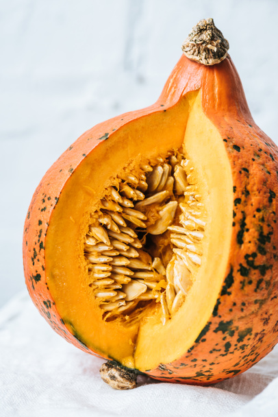 close up view of ripe pumpkin on white brick wall background - 写真・画像