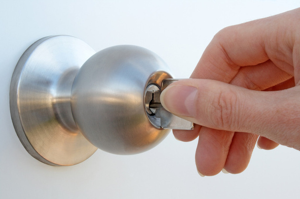 Hand unlocking the door - Photo, Image