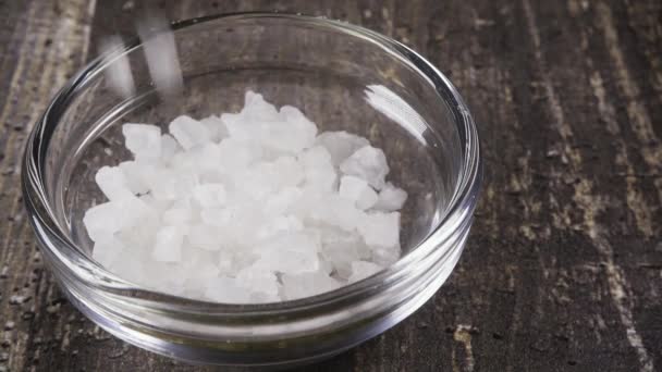 Slow motion sea salt pour into a bowl close up - Footage, Video