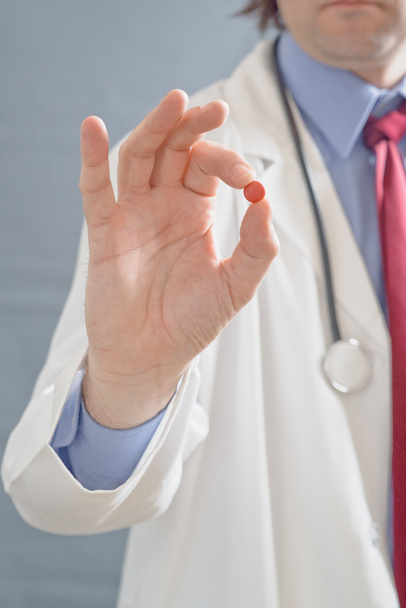 Doctor holding pill - Фото, изображение
