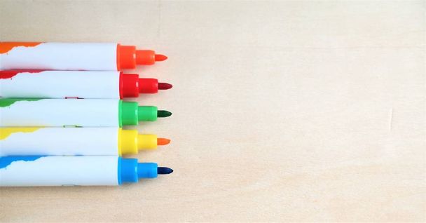 drawing material, colorful felt-tipped pens in a row, with wooden background and text space, education concept - Photo, Image