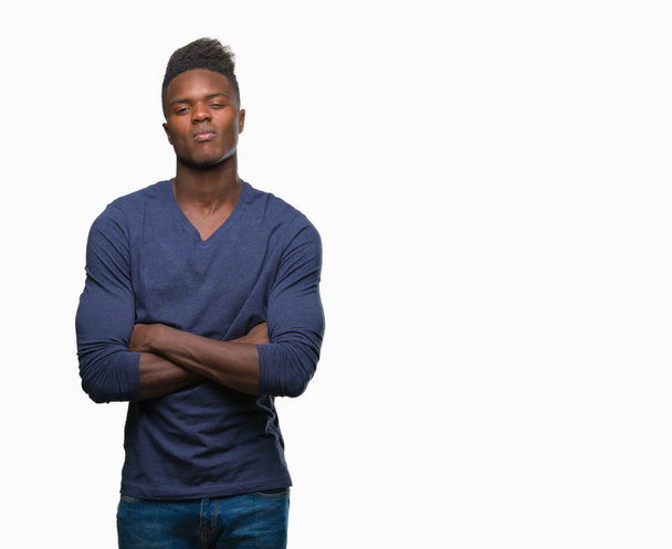 Young african american man over isolated background skeptic and nervous, disapproving expression on face with crossed arms. Negative person. - Photo, Image