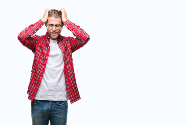 Young handsome man with long hair wearing glasses over isolated background suffering from headache desperate and stressed because pain and migraine. Hands on head. - Photo, Image