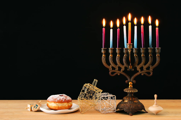 image of jewish holiday Hanukkah background with menorah (traditional candelabra) and burning candles - Fotografie, Obrázek