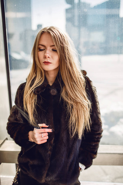 Fashion outdoor photo of a gorgeous sensual woman with blond hair in elegant clothes and a luxurious coat, walk in the autumn city - Photo, image