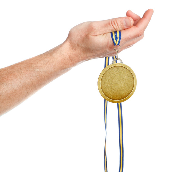 ganador de medalla de oro en la mano. sobre un fondo blanco. - Foto, Imagen