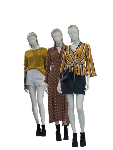 Three female mannequins dressed in fashionable clothes over white background. No brand names or copyright objects - Photo, Image