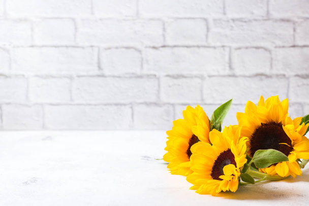 Autumn concept. Background with fresh yellow sunflowers on a white kitchen table. Copy space background - Foto, Bild
