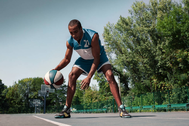 Picture of young confused african basketball player practicing - Фото, зображення