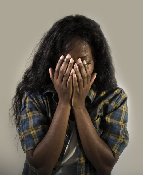 young sad and depressed black African American woman crying anxious and overwhelmed feeling sick and stressed isolated on studio background suffering depression problem and anxiety crisis - Foto, Imagem