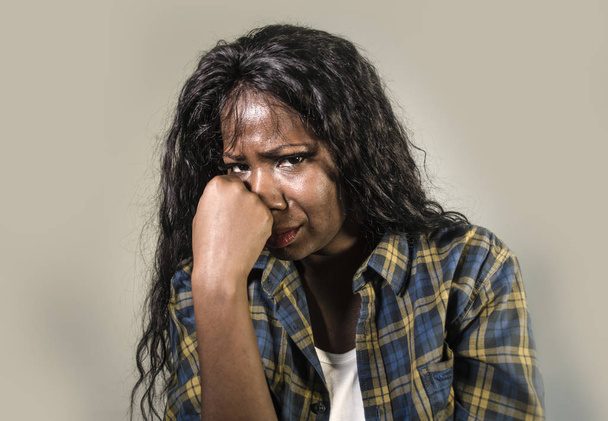 young sad and depressed black African American woman crying anxious and overwhelmed feeling sick and stressed isolated on studio background suffering depression problem and anxiety crisis - Foto, Imagen