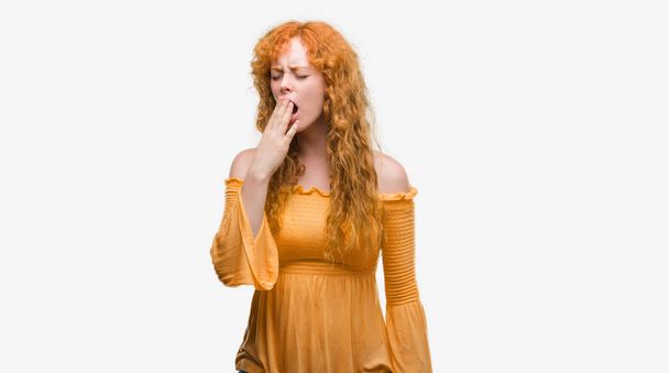 Young redhead woman bored yawning tired covering mouth with hand. Restless and sleepiness. - Photo, Image