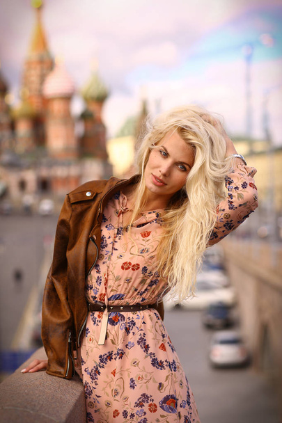 blond fashion model russian girl close up photo on red square background in Moscow center - Foto, Imagem