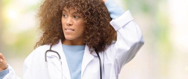 African american doctor woman, medical professional working pointing away side with finger - Photo, Image