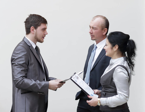 staff discuss business documents,standing in the lobby of the office - Photo, Image