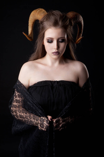 Portrait of an attractive demon woman with horns - Photo, image