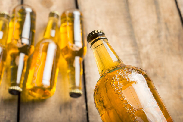 Beer bottles on a wooden table . - Foto, imagen