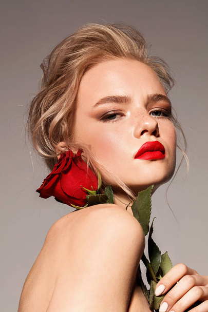 Young girl with red lips and rose. Blonde. Make up. Perfect style. - Zdjęcie, obraz