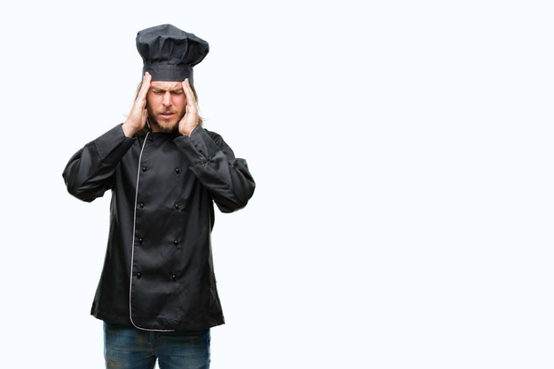 Young handsome cook man with long hair over isolated background with hand on head for pain in head because stress. Suffering migraine. - 写真・画像