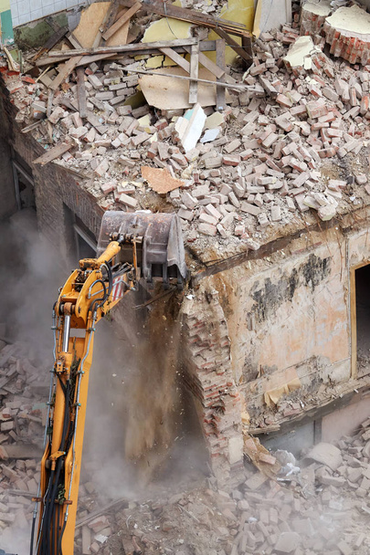Crushing brick wall, building demolition with an excavator, view from above. - Photo, Image