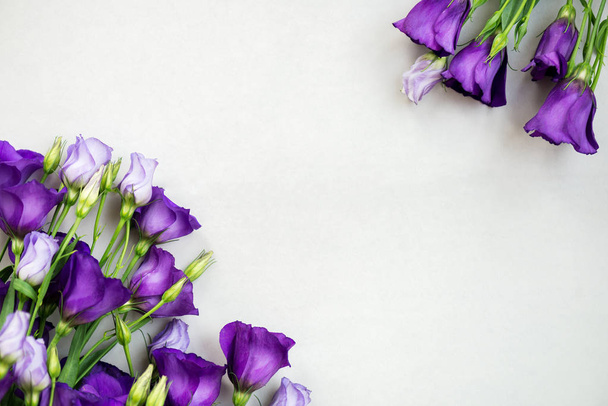 Hermoso ramo de flores de Eustoma púrpura, Lisianthus, fondo claro. Vista superior, espacio para copiar, plano
 - Foto, imagen
