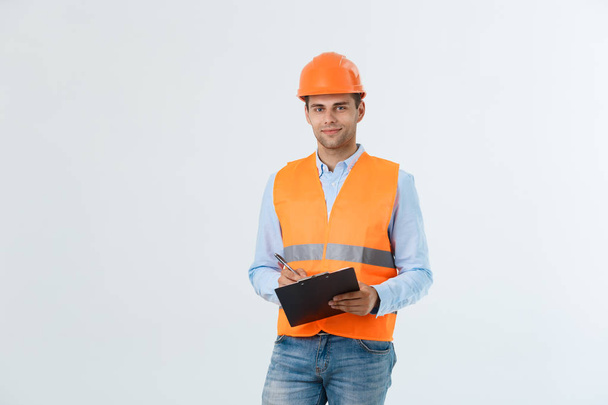 Engineers examining documents on clipboard isolated over white background. - Photo, Image