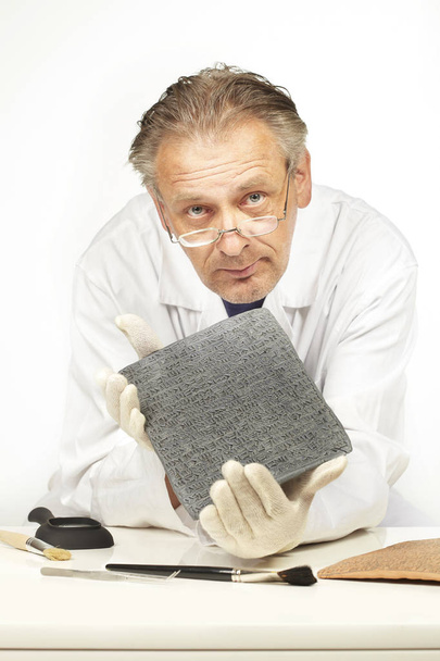 Scientist exploring ancient type of Akkad empire style cuneiform on table - Foto, Imagen