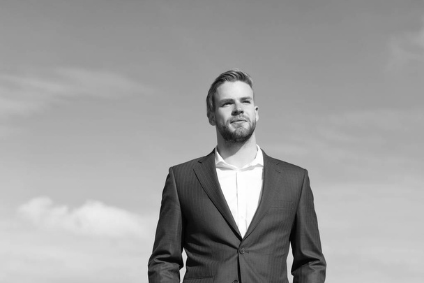 Businessman successful entrepreneur in suit walks outdoor sunny day, sky background. Man confident and well groomed enjoy freedom. Businessman attractive appearance looks successful. Freedom concept - Фото, зображення