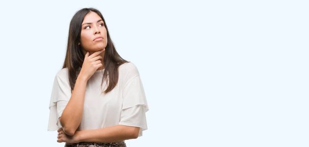 Young beautiful hispanic woman serious face thinking about question, very confused idea - Photo, Image
