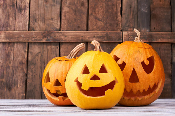 Traditional Halloween pumpkins on wooden background. - Foto, imagen