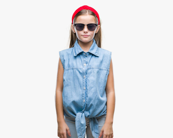 Młoda piękna dziewczyna noszenie okularów przeciwsłonecznych na na białym tle z poważną miną na twarzy. Proste i naturalne, patrząc na kamery. - Zdjęcie, obraz