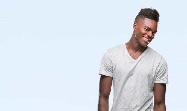 Young african american man over isolated background looking away to side with smile on face, natural expression. Laughing confident. - Foto, immagini