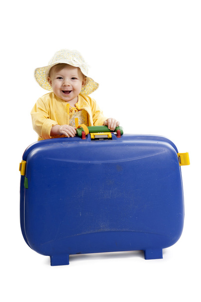 laughing baby with red and blue suitcase, on white - Zdjęcie, obraz