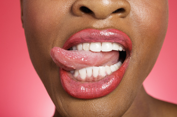 Close up of woman sticking out tongue - 写真・画像