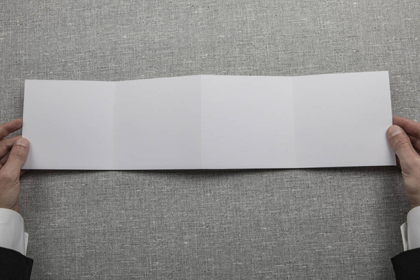 Mens hands holding empty white booklet - Valokuva, kuva