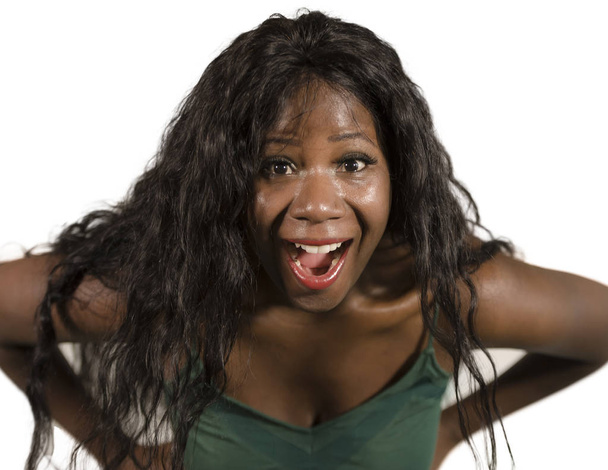isolated white background studio portrait of young happy and attractive black African American woman with long beautiful hair surprised and astonished smiling cheerful and delighted  - Foto, afbeelding