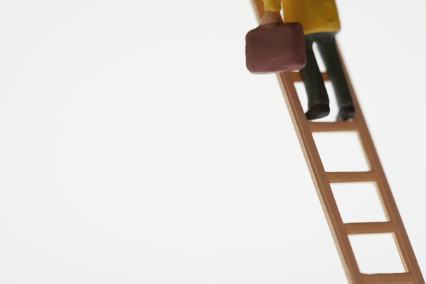 Businessman Figurine Climbing Ladder - Foto, Bild