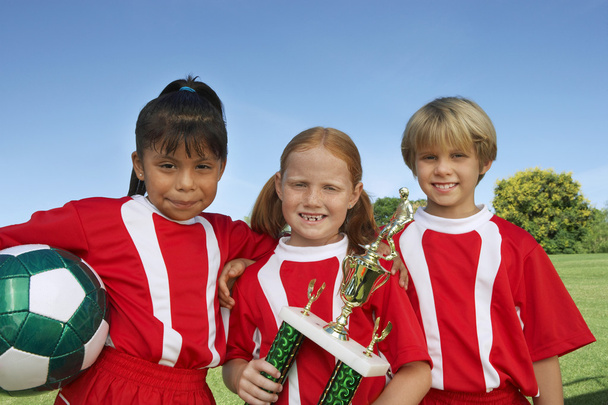 Children With Soccer Ball And Trophy - Foto, afbeelding