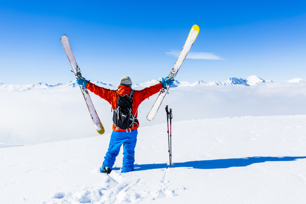 Ski in winter season, mountains and ski touring man on the top in sunny day in France, Alps above the clouds - Foto, Bild