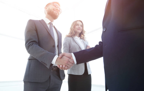 Close up business man handshake together on meeting room - 写真・画像
