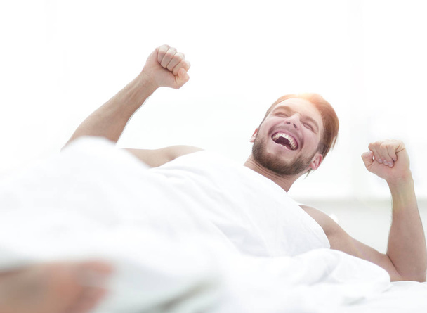 happy man waking up in the morning.photo with copy space - Foto, afbeelding