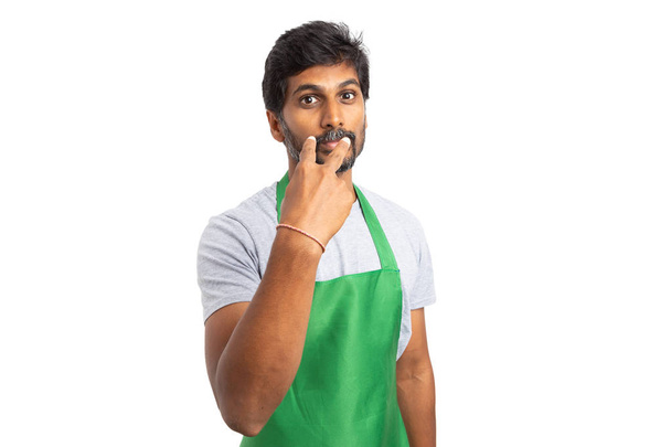 Serious supermarket or hypermarket indian employee pointing himself with look in my eyes gesture as eyes on you concept isolated on white - Photo, Image