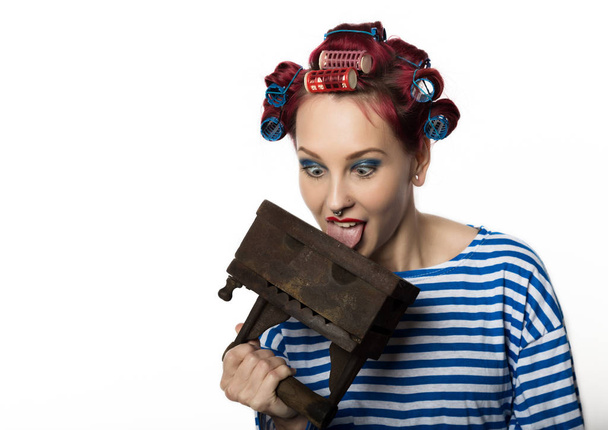 funy housewife with curlers hold vintage iron and a ladle. free space for your text - Photo, Image