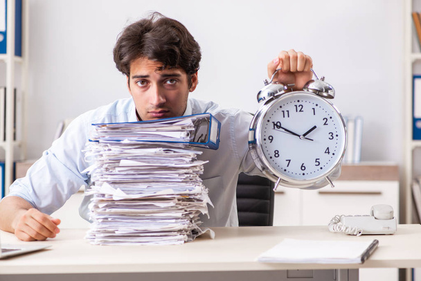 Overloaded busy employee with too much work and paperwork - Photo, Image