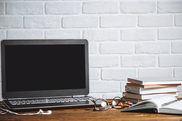 Workspace of business man or student - laptop, notebooks, pen, books, earphones on wooden desk - Zdjęcie, obraz