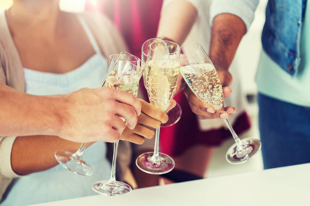 friends clinking glasses of champagne at party - 写真・画像