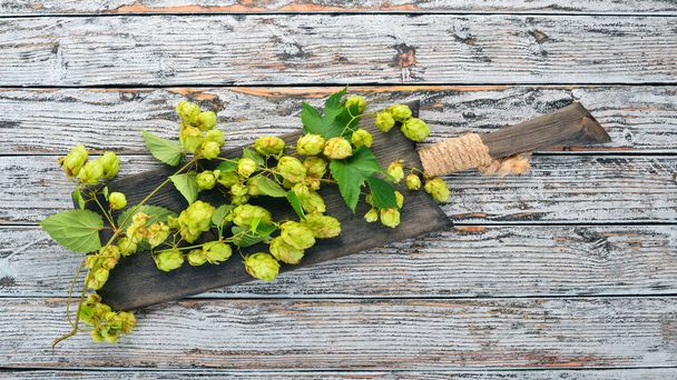Hops. On the old wooden background. Free space for text. Top view. - Photo, Image