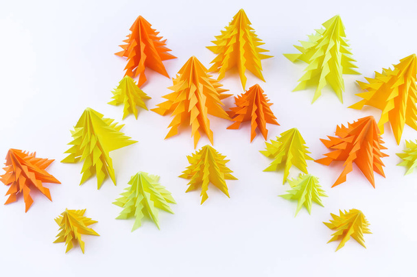 Multicolored paper Christmas tree on a white background. new Year Children's holiday. Rainbow origami - 写真・画像